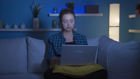 Unhappy-woman-using-laptop-laptop-at-night.-It's-not-in-a-good-mood.
